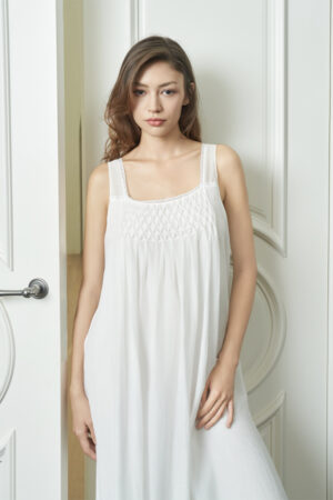A woman presents the refined elegance of the Luna Women's Nightdress, focusing on the sophisticated design of the upper silhouette.