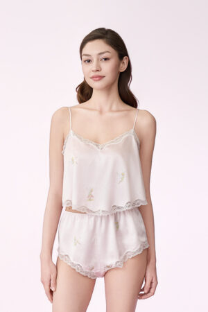 Woman wearing the pink Enchanted Charm Silk Short Camisole Set, front view showing the lace-trim camisole and matching silk shorts.